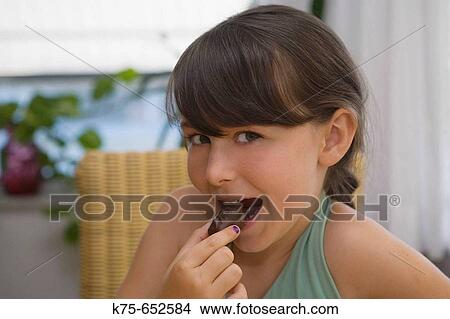 Enjoying chocolate View Large Photo Image Picture - Enjoying chocolate. Fotosearch