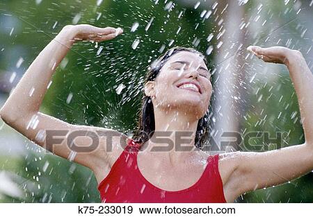 Enjoying the spray of water View Large Photo Image Stock Photo - Enjoying the spray of water. Fotosearch