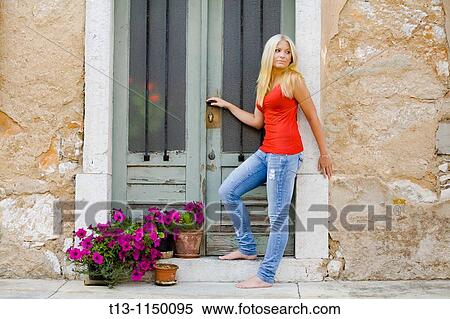 Entering Mediterranean style traditional house young woman View Large Photo Image Stock Photography - Entering Mediterranean style traditional house young woman. Fotosearch