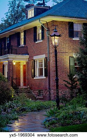 Picture - Entrance of a house illuminated by a gas lamp.. Fotosearch