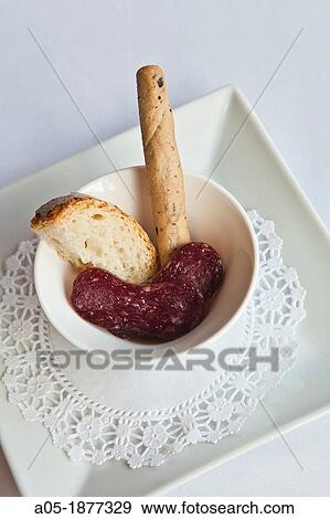 Stock Photo - Er Occitan Restaurant, Organya macerated salami with olive oil of Garrigues and bread, Bossost, Naut Aran, Aran Valley, Pyrenees, Lleida province, Catalonia, Spain. Fotosearch