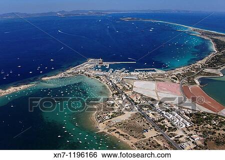 Es Savina harbor, Des Peix lagoon on the left and a little of the Pudent lagoon on the right, Ibiza in the distance, Formentera, Balearic Islands, Spain View Large Photo Image Stock Photograph - Es Savina harbor, Des Peix lagoon on the left and a little of the Pudent lagoon on the right, Ibiza in the distance, Formentera, Balearic Islands, Spain. Fotosearch