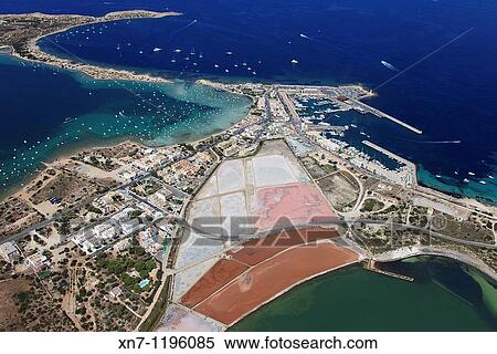 Es Savina harbor, Des Peix lagoon on the middle left and Pudent lagoon at botton, Formentera, Balearic Islands, Spain View Large Photo Image Stock Photography - Es Savina harbor, Des Peix lagoon on the middle left and Pudent lagoon at botton, Formentera, Balearic Islands, Spain. Fotosearch