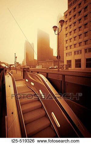 Escalator in front of skyscrapers, Potzdamer Platz, Berlin, Germany View Large Photo Image Stock Photograph - Escalator in front of skyscrapers, Potzdamer Platz, Berlin, Germany. Fotosearch