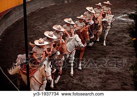 Picture - Escaramuzas ride their horses before competing in an Escaramuza competition in the Lienzo Charros del Pedregal, Mexico City. Fotosearch