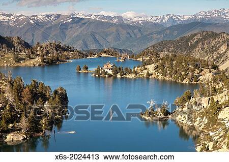 Stock Image - Estany Tort de la Peguera lake and JM Blanc mountain hut, National Park of Aig? estortes, Lleida, Spain.. Fotosearch
