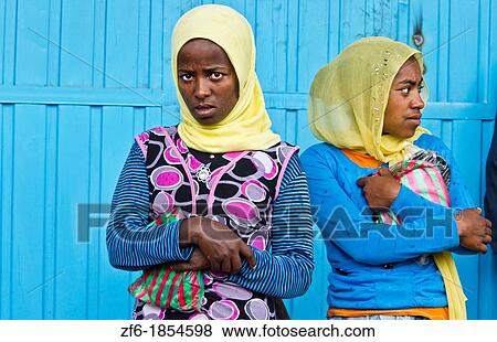 Ethiopia, Addis Ababa, Two young women against blue door View Large Photo Image Stock Photo - Ethiopia, Addis Ababa, Two young women against blue door. Fotosearch