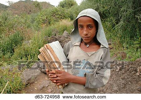 ETHIOPIA Tullo Gudo island and it's monastery of Debre Zion, Lake Ziway Girl walking to school carrying her books View Large Photo Image Stock Photo - ETHIOPIA Tullo Gudo island and it's monastery of Debre Zion, Lake Ziway Girl walking to school carrying her books. Fotosearch