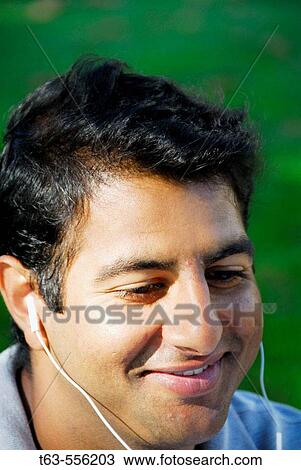 ethnic man listening to music View Large Photo Image Stock Image - ethnic man listening to music. Fotosearch