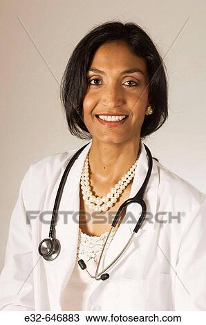 Ethnic woman in white lab coat with stethoscope View Large Photo Image Stock Image - Ethnic woman in white lab coat with stethoscope. Fotosearch