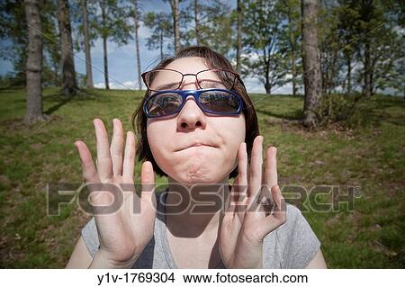Picture - Eurasian teenage girl at a park. Fotosearch