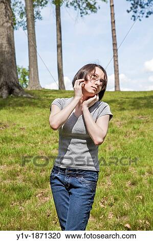 Eurasian teenage girl at a park View Large Photo Image Stock Image - Eurasian teenage girl at a park. Fotosearch