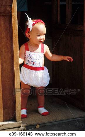 Eurasian toddler girl standing in doorway, sunlit from side, Southern California, USA View Large Photo Image Stock Image - Eurasian toddler girl standing in doorway, sunlit from side, Southern California, USA. Fotosearch