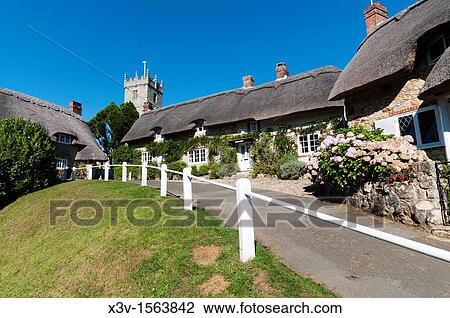 Stock Image - Europe, England, Isle of Wight, Godshill - thatched cottages on Church Hill, leading to All Saints Church. Fotosearch