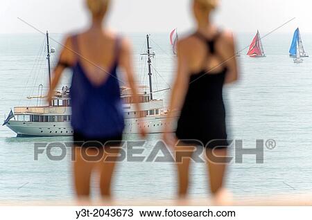 Stock Image - Europe, France, Alpes-Maritimes, Antibes. Couple jogger front of the sea view from the Mariejol place.. Fotosearch