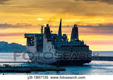 Stock Photography - Europe, France, Bouches-du-Rhone, 13, Marseille, European Capital of Culture 2013, 2nd District, Zone Eurom? diterran? e. Cruise ship leaving the port at sunset.. Fotosearch