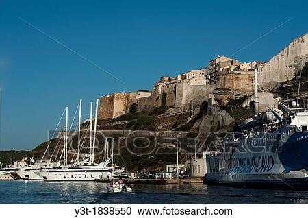 Europe, France, Corse-du-Sud (2A), Bonifacio. Cruise Ships and Sailboats in a Marina front of the ramparts. View Large Photo Image Stock Image - Europe, France, Corse-du-Sud (2A), Bonifacio. Cruise Ships and Sailboats in a Marina front of the ramparts.. Fotosearch