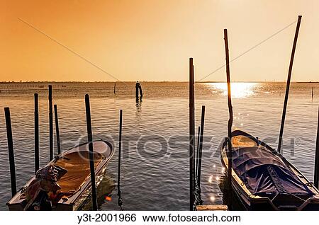 Europe, Italy, Veneto, Burano, classified as World Heritage by UNESCO. Boat on the lagoon at sunset. View Large Photo Image Stock Photograph - Europe, Italy, Veneto, Burano, classified as World Heritage by UNESCO. Boat on the lagoon at sunset.. Fotosearch