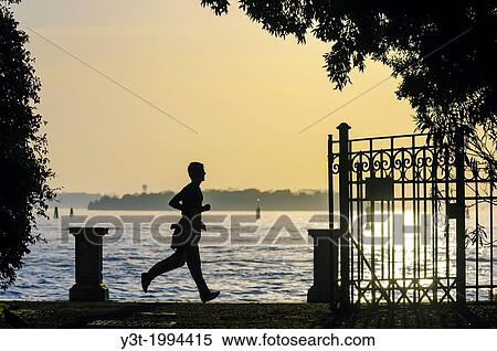 Europe, Italy, Veneto, Venice, classified as World Heritage by UNESCO. Jogger in front of lagoon. View Large Photo Image Stock Photography - Europe, Italy, Veneto, Venice, classified as World Heritage by UNESCO. Jogger in front of lagoon.. Fotosearch