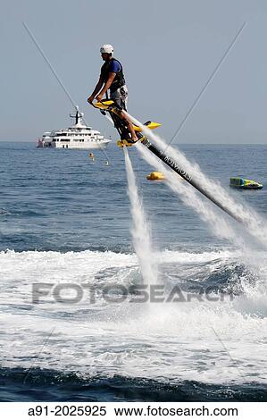 Europe, Principality of Monaco, Montecarlo Beach resort and hotel property of SBM (Societe des Bains de Mer), practising the new aquatic sport called Flyboard. View Large Photo Image Stock Photography - Europe, Principality of Monaco, Montecarlo Beach resort and hotel property of SBM (Societe des Bains de Mer), practising the new aquatic sport called Flyboard.. Fotosearch