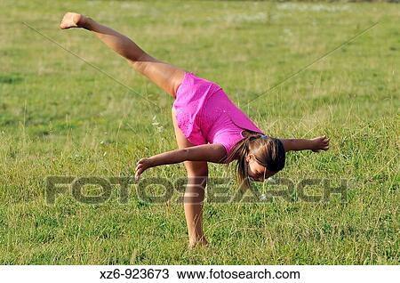 European young doing gymnastics in a meadow in the Pyrenees View Large Photo Image Stock Image - European young doing gymnastics in a meadow in the Pyrenees. Fotosearch