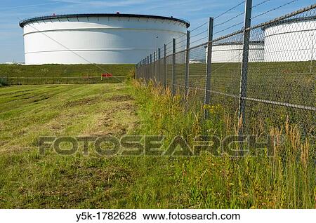 Europoort, Rotterdam, Netherlands. Storage-ranks for oil, fuel and chemicals behind a meadow in Rotterdam harbor. View Large Photo Image Stock Photo - Europoort, Rotterdam, Netherlands. Storage-ranks for oil, fuel and chemicals behind a meadow in Rotterdam harbor.. Fotosearch