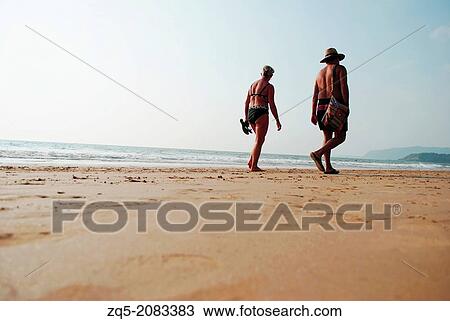 Stock Image - Evening beach walk, India.. Fotosearch