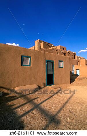 Stock Image - Evening light on the 3-story adobe North House (World Heritage Site), Taos Pueblo, New Mexico USA.. Fotosearch