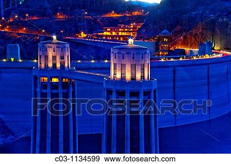 Evening view of Hoover Dam, a concrete arch-gravity dam in the Colorado River on the border between the U S states of Arizona and Nevada Note penstock towers at dam supplying water to its hydroelectric plant View Large Photo Image Stock Photo - Evening view of Hoover Dam, a concrete arch-gravity dam in the Colorado River on the border between the U S states of Arizona and Nevada Note penstock towers at dam supplying water to its hydroelectric plant. Fotosearch
