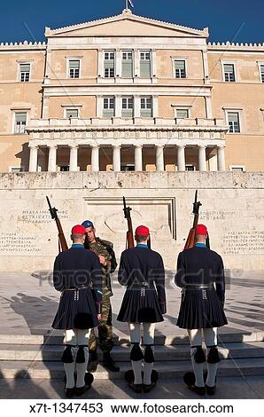 Evzones, an elite core of Greek soldiers used to guard the tomb of the unknown soldier infront of the Hellenic Parliament building in Syndagma Square in the center of Athens, Greece Their uniform is derived from traditional greek mountain costumes View Large Photo Image Stock Image - Evzones, an elite core of Greek soldiers used to guard the tomb of the unknown soldier infront of the Hellenic Parliament building in Syndagma Square in the center of Athens, Greece Their uniform is derived from traditional greek mountain costumes. Fotosearch