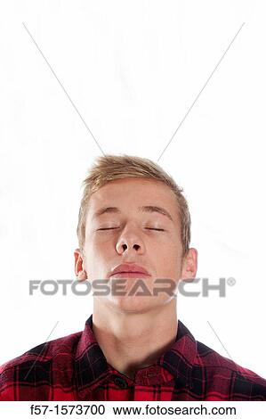 Stock Image - Exasperated young man with his eyes shut. Fotosearch