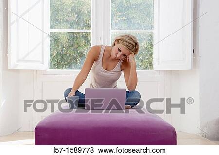 Exasperated young woman online View Large Photo Image Stock Photo - Exasperated young woman online. Fotosearch