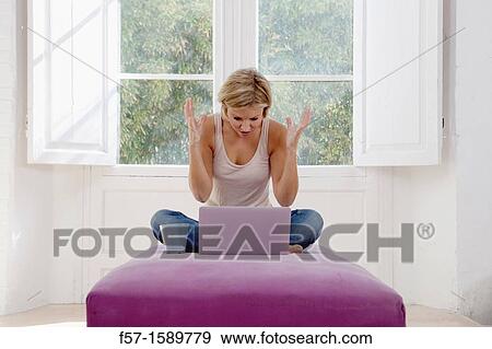 Stock Photo - Exasperated young woman online. Fotosearch