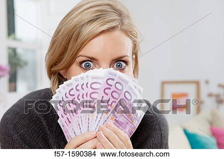 Excited woman holding 500 Euro notes View Large Photo Image Picture - Excited woman holding 500 Euro notes. Fotosearch