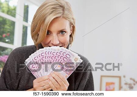 Excited woman holding 500 Euro notes View Large Photo Image Stock Image - Excited woman holding 500 Euro notes. Fotosearch
