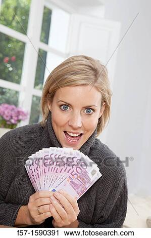 Stock Image - Excited woman holding 500 Euro notes. Fotosearch