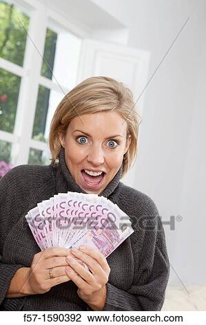 Excited woman holding 500 Euro notes View Large Photo Image Stock Image - Excited woman holding 500 Euro notes. Fotosearch