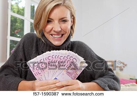 Excited woman holding 500 Euro notes View Large Photo Image Stock Photo - Excited woman holding 500 Euro notes. Fotosearch