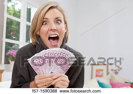 Excited woman holding 500 Euro notes View Large Photo Image Stock Photo - Excited woman holding 500 Euro notes. Fotosearch