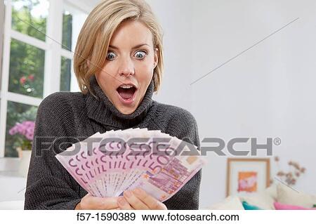 Stock Photo - Excited woman holding 500 Euro notes. Fotosearch