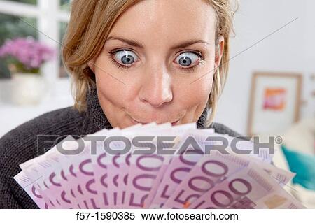 Excited woman holding 500 Euro notes View Large Photo Image Stock Photography - Excited woman holding 500 Euro notes. Fotosearch
