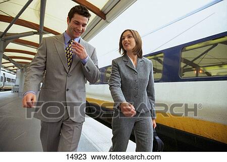 Executive couple at train station View Large Photo Image Stock Image - Executive couple at train station. Fotosearch
