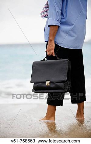 Executive in the beach, out of place View Large Photo Image Stock Image - Executive in the beach, out of place. Fotosearch