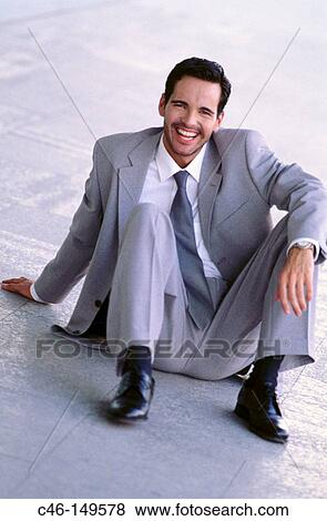 Executive sitting on floor View Large Photo Image Stock Photo - Executive sitting on floor. Fotosearch