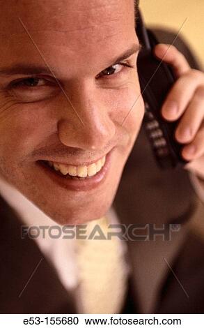 Executive talking on cell phone View Large Photo Image Stock Image - Executive talking on cell phone. Fotosearch