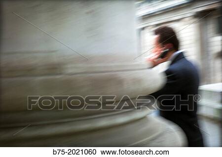 executive talking on phone leaning against a pillar in the building of the old stock exchange market, city of London, UK View Large Photo Image Stock Image - executive talking on phone leaning against a pillar in the building of the old stock exchange market, city of London, UK. Fotosearch