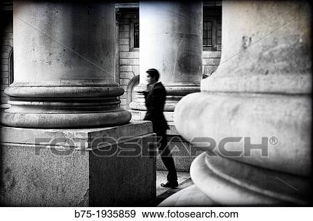 Executive talking on the phone walking out of the old Stock Exchange building in London, England, UK View Large Photo Image Stock Photo - Executive talking on the phone walking out of the old Stock Exchange building in London, England, UK. Fotosearch