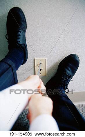 Executive trying to pull plug out of jack View Large Photo Image Stock Photography - Executive trying to pull plug out of jack. Fotosearch