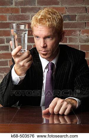 Executive with glass of water View Large Photo Image Stock Photograph - Executive with glass of water. Fotosearch