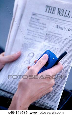 Executive woman with financial newspaper talking on cellular phone View Large Photo Image Stock Photography - Executive woman with financial newspaper talking on cellular phone. Fotosearch